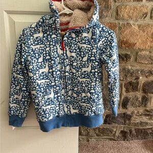 Blue hoodie with nature patterns, furry inside size 9 to 10-year-olds, zip up.